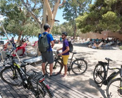 Cyclists ebiker at Vouliagmeni Lagoon Greece