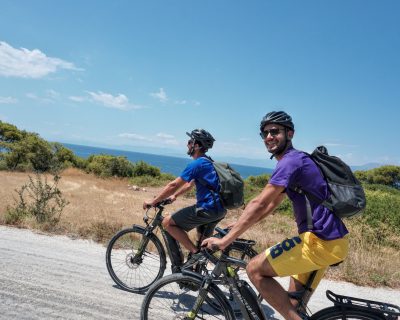 Cyclists ebiker at Vouliagmeni Lagoon Greece