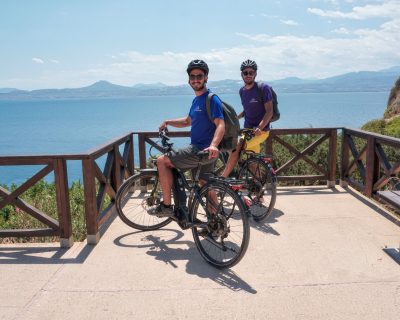 Cyclists ebiker at Vouliagmeni Lagoon Greece