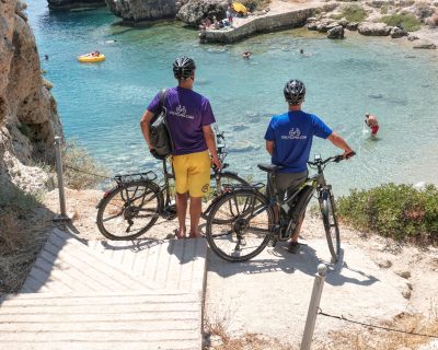 Cyclists ebiker at Vouliagmeni Lagoon Greece